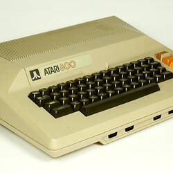 Three quarter view of beige plastic unit with keyboard.