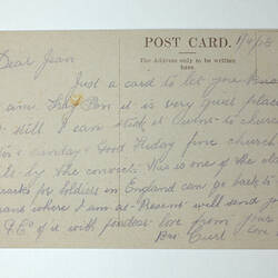 Printed back of postcard with handwriting.