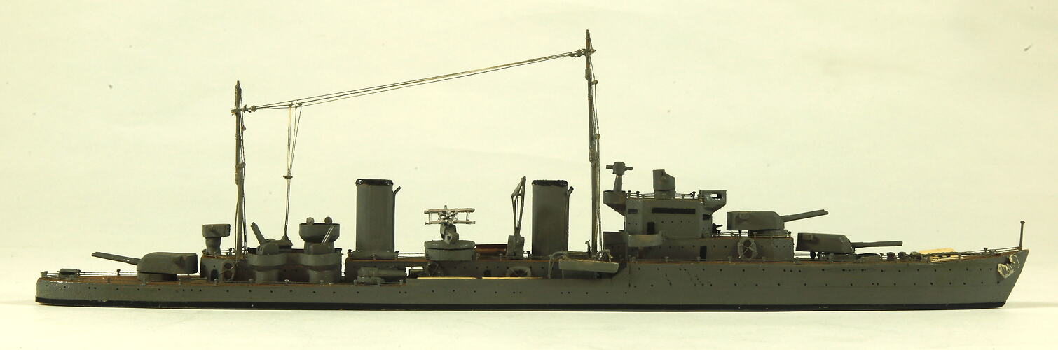 Naval ship with two masts, facing right.