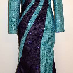 Light blue full length sequin dress with dark blue swirls from shoulder to hip.