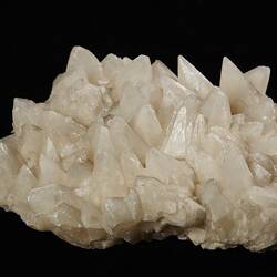 White/cream mineral with pointy crystals.