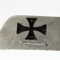 Model of a bi-plane made mostly of aluminium sheet metal. Detail view of wing with cross.