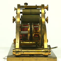 Brass apparatus with batteries on metal base