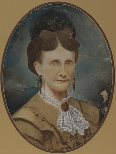 Bust of lady wearing fine brown dress and intricate lace collar with brooch. Drop earrings and hair up.