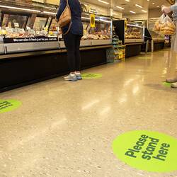 Green floor marker in supermarket.