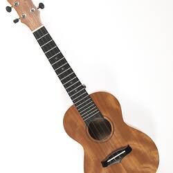 Light brown ukulele.