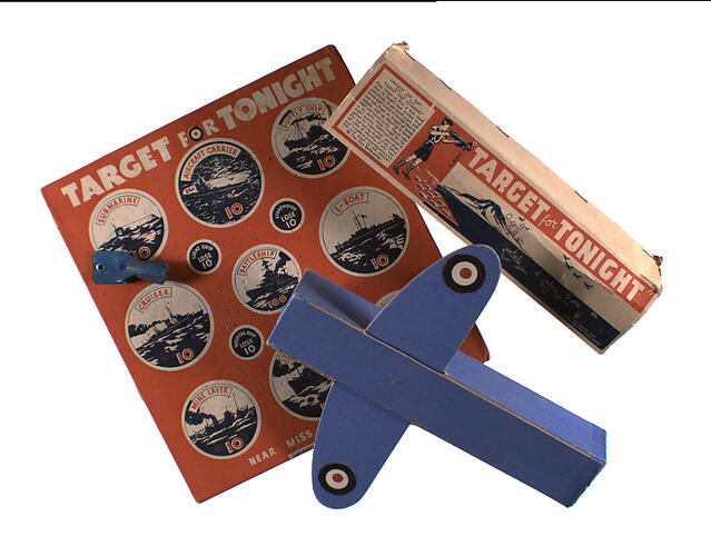 Game board with aeroplane and box on top.
