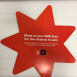 Red star-shaped placard with white printed text. Two logos.