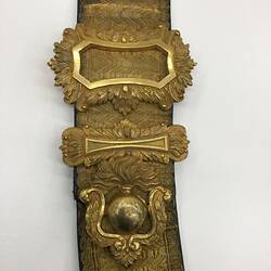 Detail of gold shoulder pouch belt.