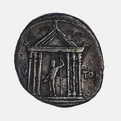 Irregular round coin with standing figure within temple holding lightning bolt and sceptre.