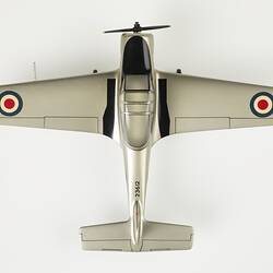 Top view model aeroplane, silver with black propeller and wheels. Red, white, blue roundels on wings.
