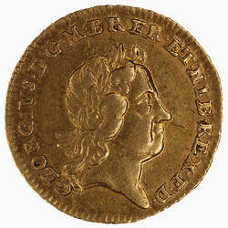 Round gold coin with head.
