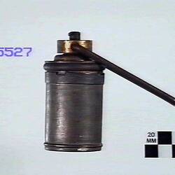 Side view of metal detonator.