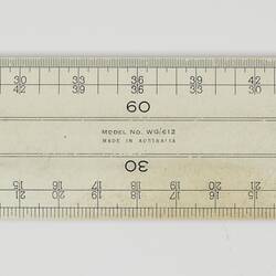 White plastic ruler with black markings.