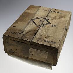 Wooden crate with black ink printing.