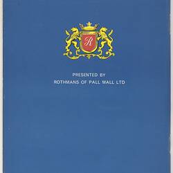 Blue cover with coat of arms. Red shield, gold crown atop, gold lions each side. White text.