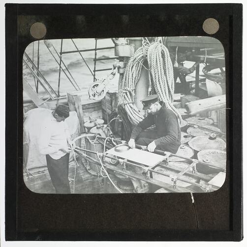 Lantern Slide - Two RAAF Party Members Binding a Snow Sledge, Ellsworth Relief Expedition, Antarctica, 1935-1936