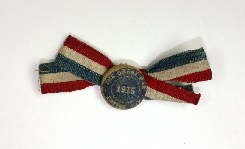 Round cloth Badge with red, white and blue ribbon.