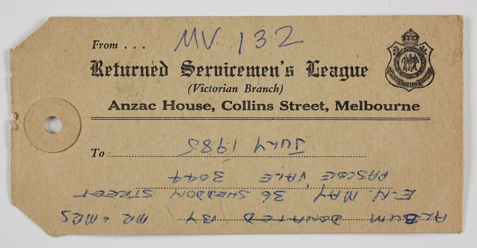 Paper tag on thick brown card stock, with black printed and blue handwritten text.