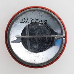 Metal back of round badge. Has horizontal pin.