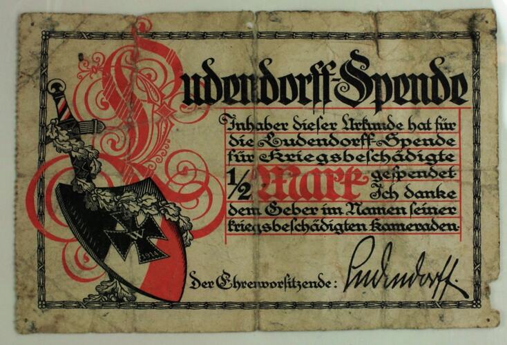 Black and red shield with black and red print in German.