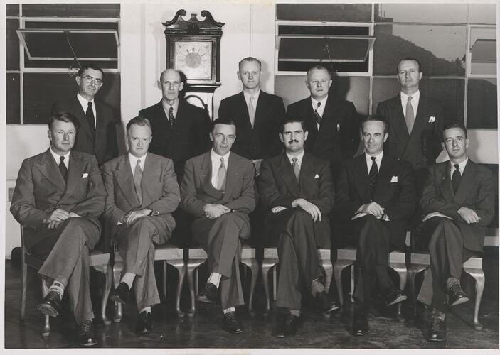 Group portrait of 11 men in office.