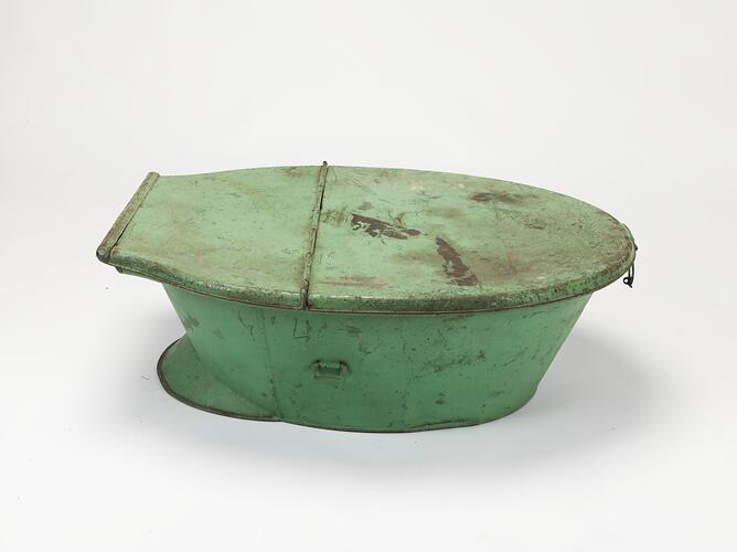 Green painted metal travel bath with lid.