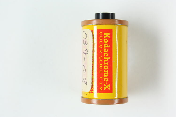 Cylindrical cartridge with sticker and printed metal label.