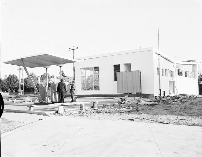 Monochrome photograph of a petrol station.