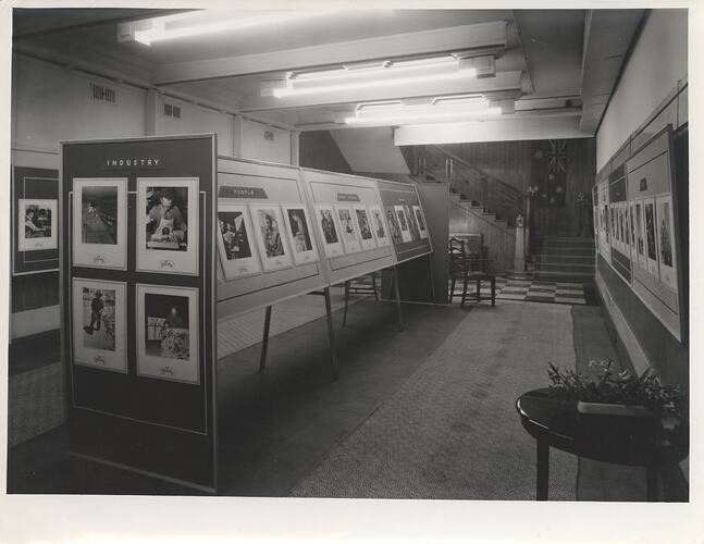 Aisle of photography exhibition with framed images.