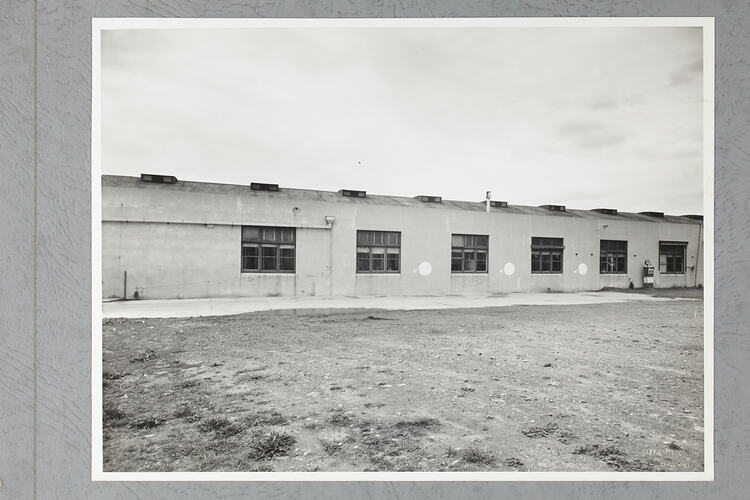 Monochrome photograph of a showroom exterior.