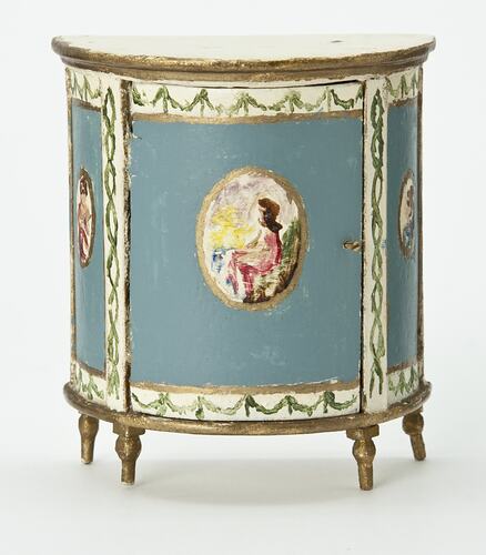 Semi-circular bedside table painted blue and cream with gold edging. Central oval portrait.