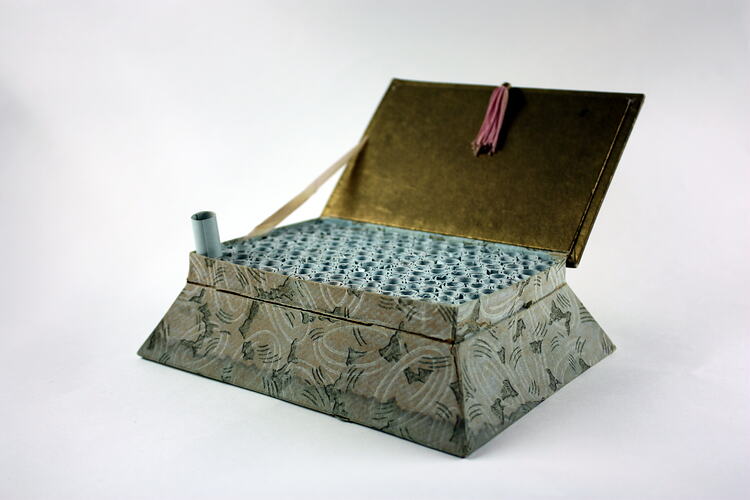 Open box with scrolls inside.