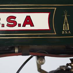 Green, cream motor cycle, red lettering. Left tank profile.
