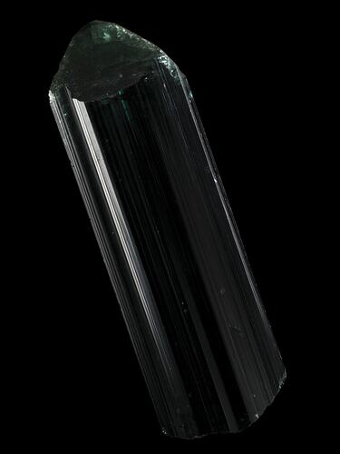 Dark green prsimatic crystal on black background.