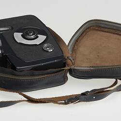 Blue plastic camera within grey leather case.