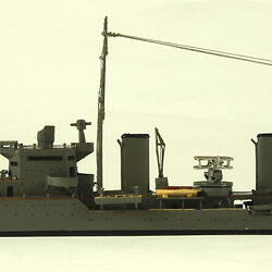 Naval ship with two masts, facing left.
