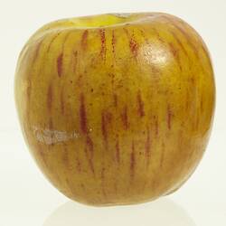 Wax apple model painted yellow with red flecks.