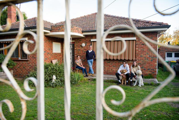 Family behind their front fence during COVID-19 lockdowns, Fairfield, Victoria, 22 April 2020