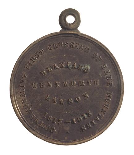 Medal with raised text. Loop at top.