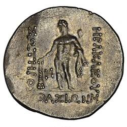 Herakles standing naked, head left, holds lion's skin in left arm and club in right. Text around.