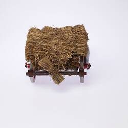 Back view of model wagon loaded with hay.