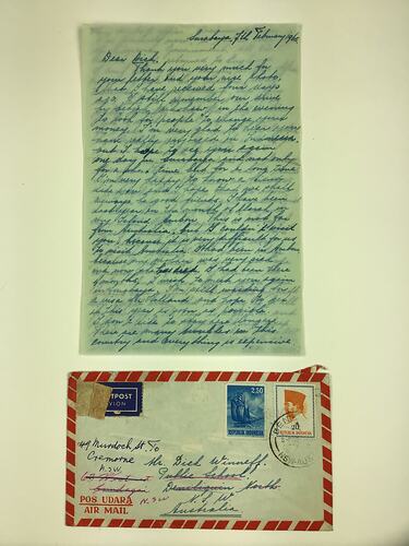 Handwritten letter and addressed envelope with blue, white and red trim.