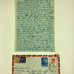 Handwritten letter and addressed envelope with blue, white and red trim.