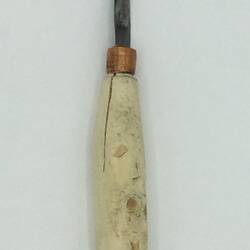 Knife with partially carved wooden handle and small blade.