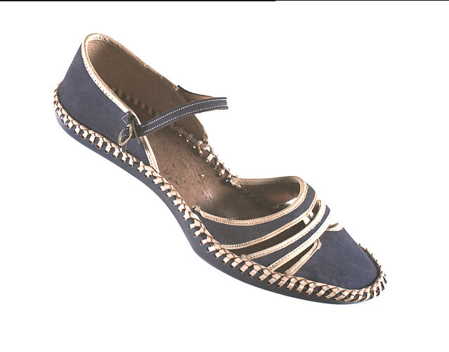 Blue shoe with cream trim and ankle strap.