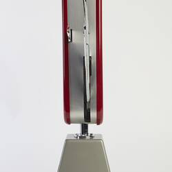 Model of muti-tool on stand. Red handle with all tools out. Side view.