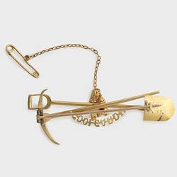 Gold miners brooch with pick and shovel motif. Back view.