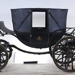 Black coach with four rubber tyres. Yellow and brown lining, and the Australian coat of arms on each door.