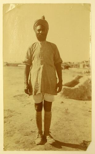 Portrait of an Indian cavalry man standing outdoors.